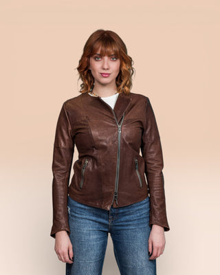 Jane women's brown leather biker jacket, worn closed by model, front view.