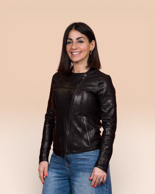 Jane women's black leather biker jacket, worn closed by model, front 3/4 view.