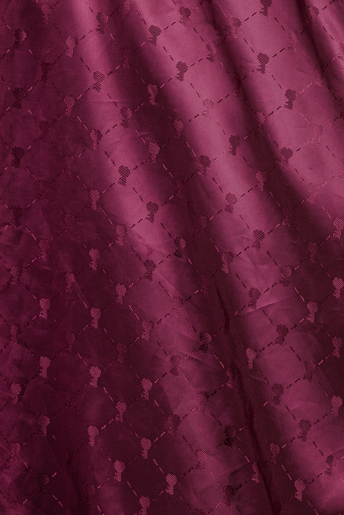 Detail of the red inner lining of the Jasmine leather jacket, featuring the heart-shaped key, a symbol of the brand.