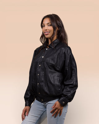 Angled view of a model wearing the Jasmine oversized women’s black leather jacket.