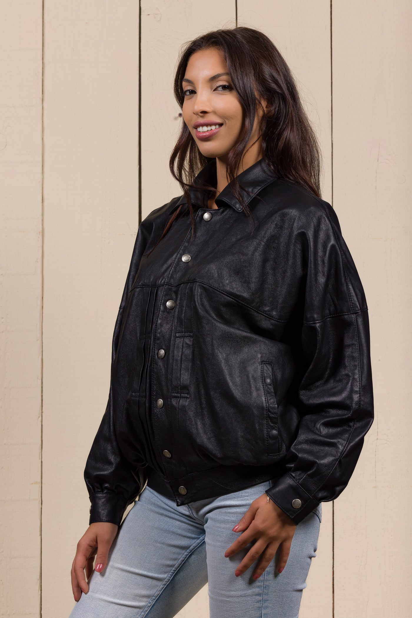 Angled view of a model wearing the Jasmine oversized women’s black leather jacket.