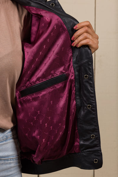 Close-up of the inner red lining and internal pocket of the Jasmine black leather jacket with Benheart logo.