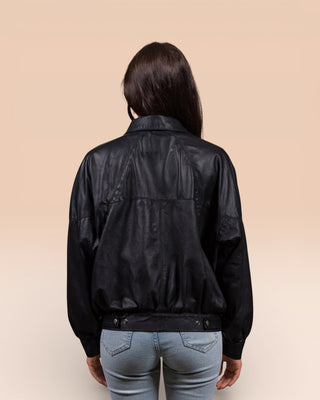 Rear view of a model wearing the Jasmine oversized black leather jacket for women.