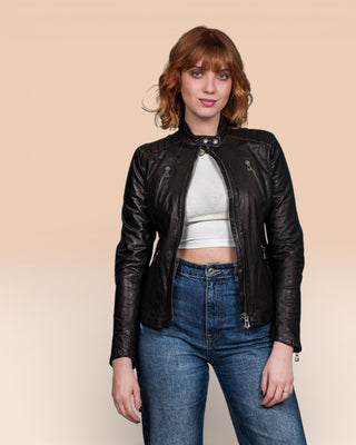 Front view of model wearing Lory women's black leather biker jacket, jacket open, collar buttoned.