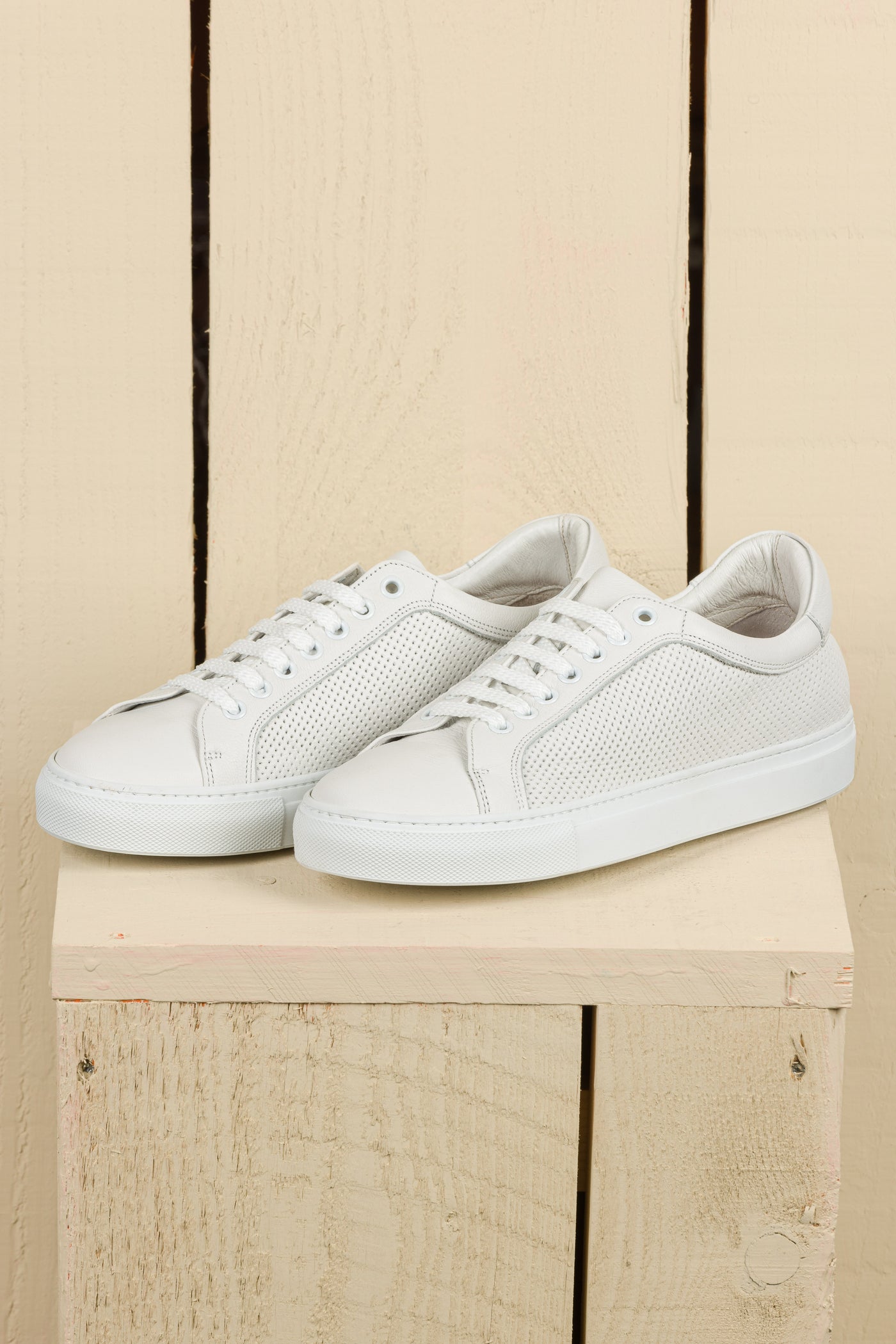 front angled view of Benheart Lario unisex white perforated leather low-top sneakers