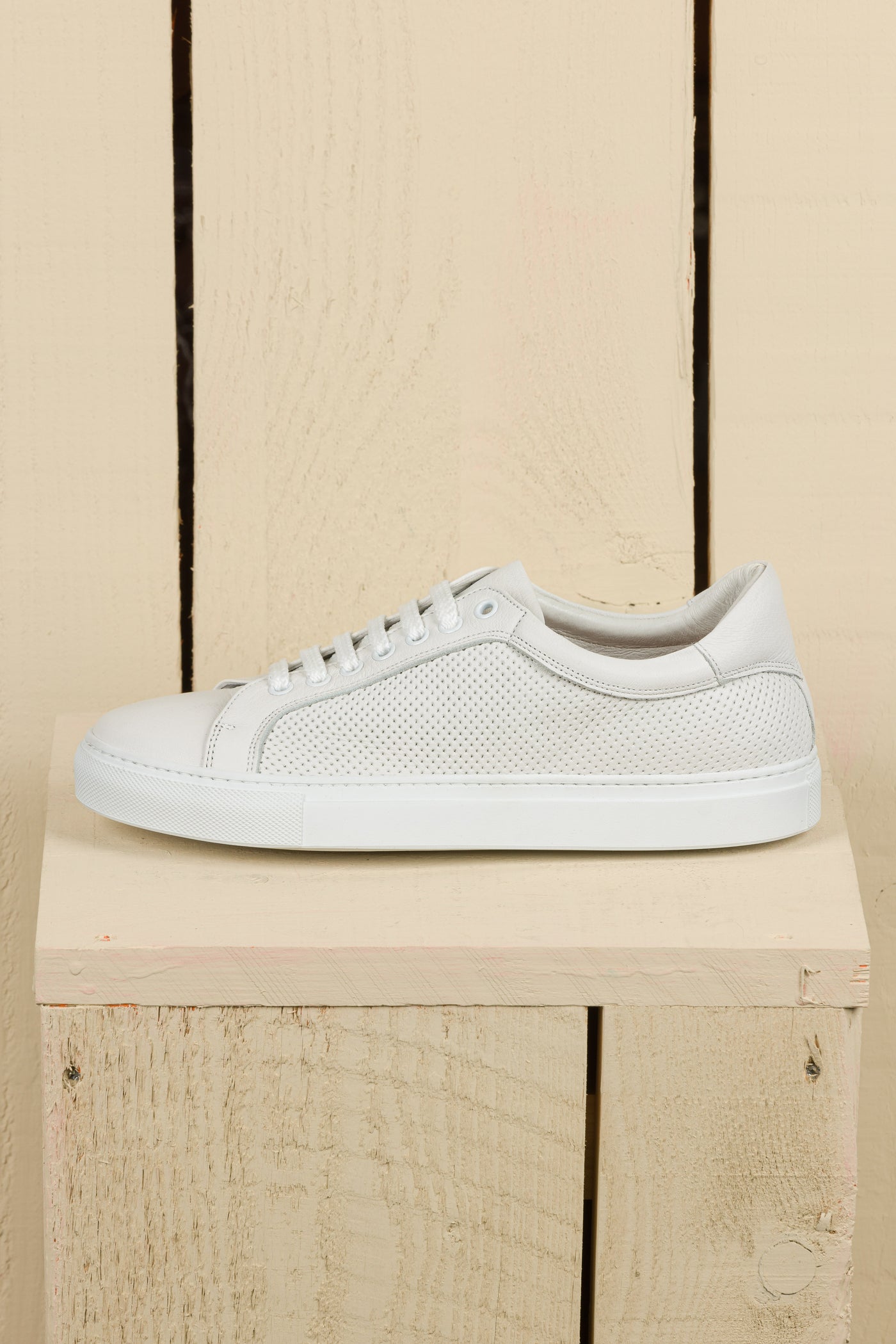 Benheart Lario unisex white perforated leather low-top sneakers, side view.