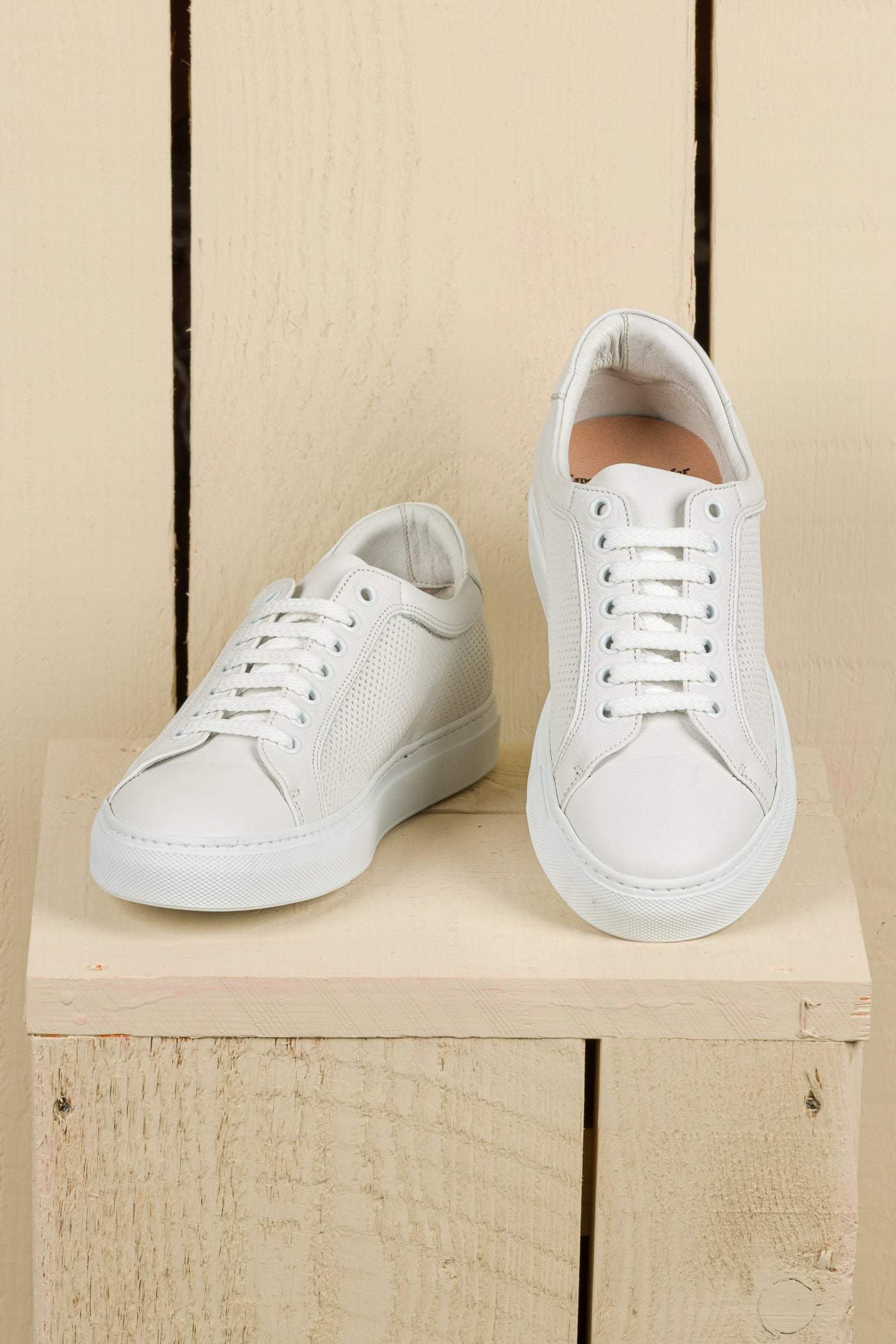 Front angled and top view of Benheart Lario unisex perforated leather sneakers shoes in white color.