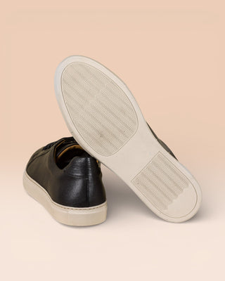 Benheart Leclerc men’s black leather low-top sneakers, rear view with one shoe showing the white rubber sole.