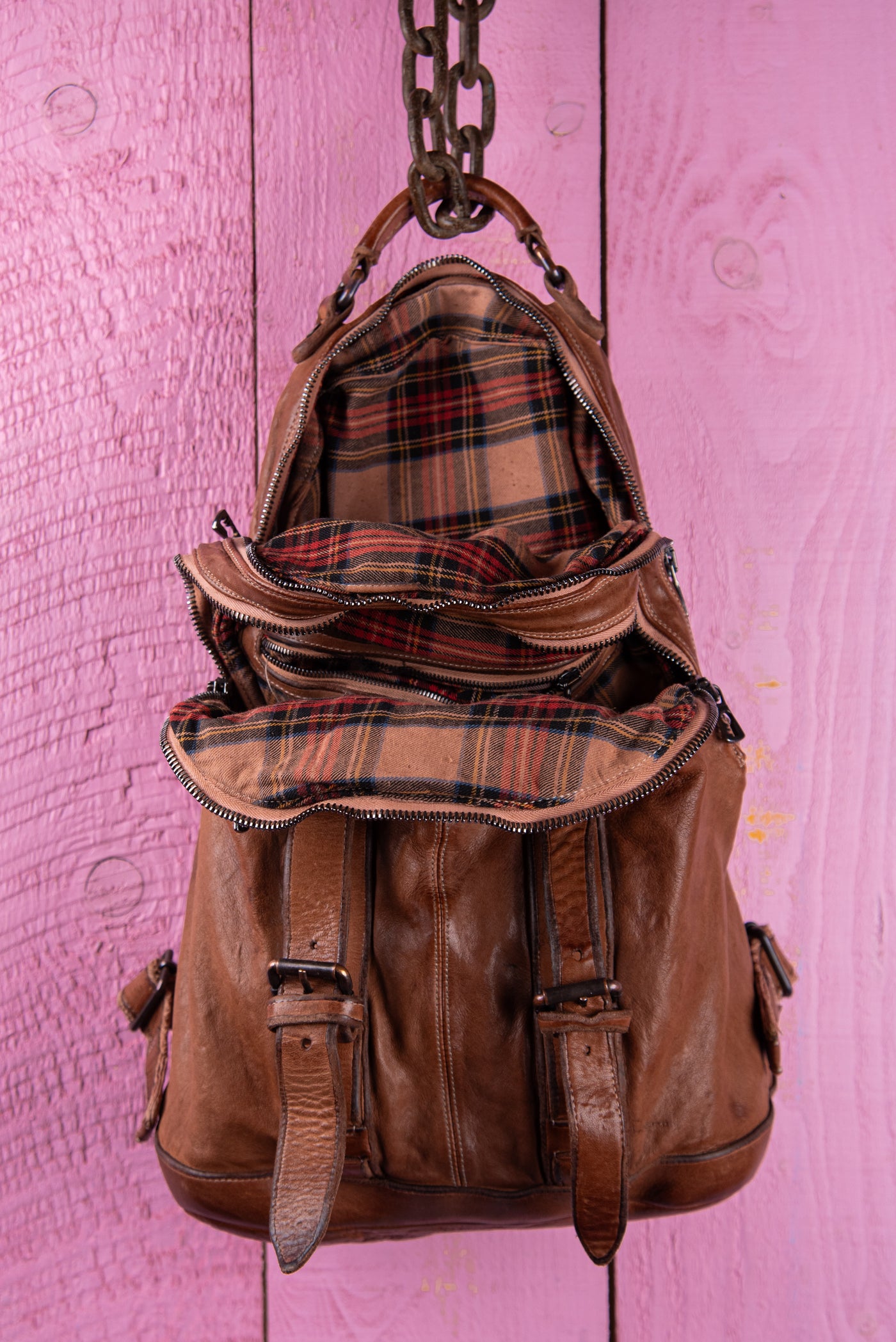Benheart Lorenzo unisex leather backpack in cuoio, front view with open compartment showing interior.