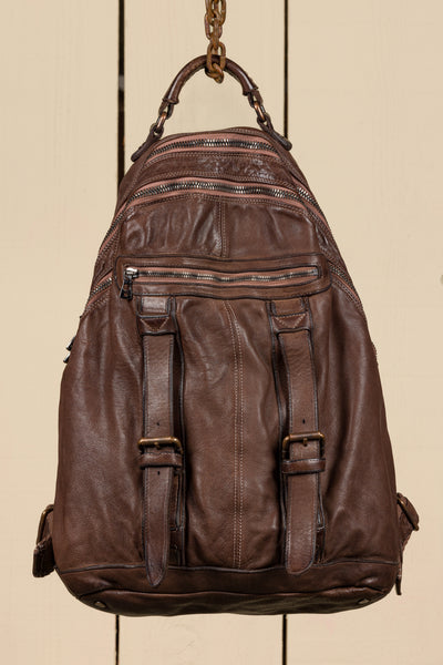 Front view of the Benheart Lorenzo unisex leather backpack in brown, showing front pockets and zipper details.