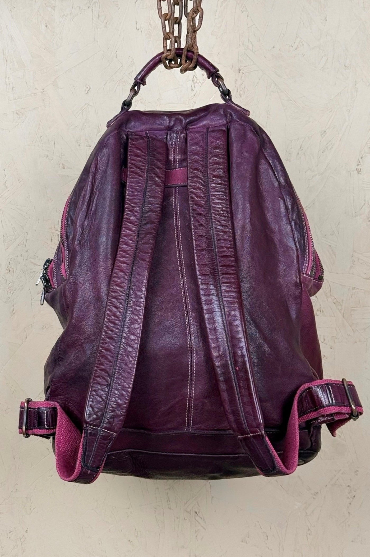 Benheart Lorenzo unisex leather backpack in plum, rear view showing adjustable shoulder straps.