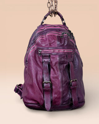 Lorenzo unisex leather backpack by Benheart in plum, showing front pockets and zipper details, front view.