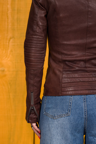 Back view detail of left sleeve on Lory women's brown leather biker jacket, showing Benheart logo zipper.