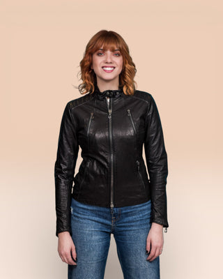 Front view of model in Lory women's black leather biker jacket, worn closed.