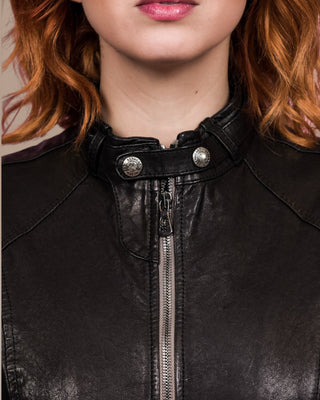 Close-up of front zipper with Benheart logo and collar straps on Lucia women's black leather jacket.