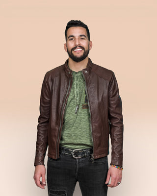 Front view of a model wearing the Madison leather jacket by Benheart in brown, worn open.