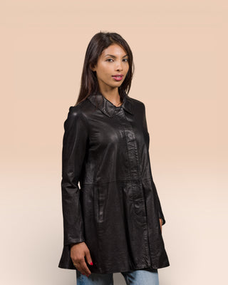Model wearing the Mini women's leather jacket in black, handcrafted in Italy by Benheart, worn closed. front angled view.