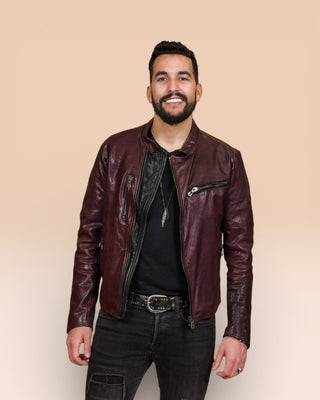 Front view of a model wearing the NELSON Limited Edition leather jacket in plum color, worn open to reveal the inner layer.