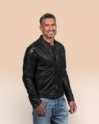 Model shown in a three-quarter angle wearing the black Nelson leather jacket by Benheart, partially open at the front.