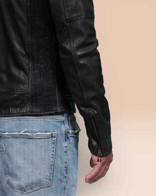 Detail of the sleeve and zipper closure on the back of the right arm, worn by the model in the black Nelson leather jacket