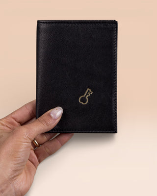 Model’s hand holding a black New York wallet by Benheart, made in Italy from genuine leather