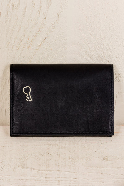 Horizontal view of closed black New York wallet by Benheart, featuring logo on the front