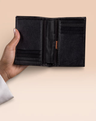 Model’s hand holding open black New York wallet by Benheart, made in Italy from genuine leather