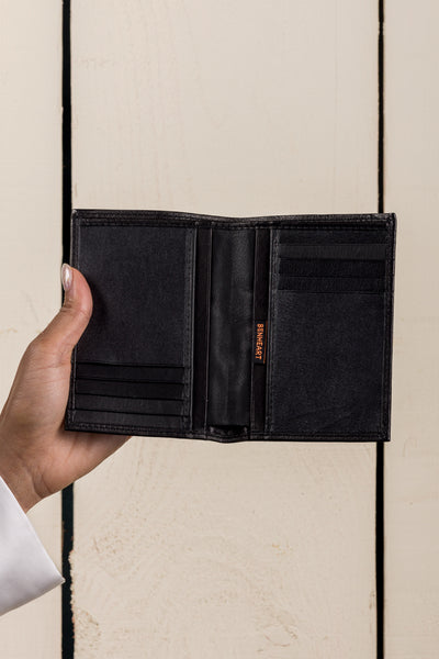 Model’s hand holding open black New York wallet by Benheart, made in Italy from genuine leather
