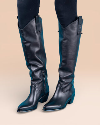 Front-angled view of a model wearing black Novelli high Texan boots by Benheart, featuring a side zip closure.