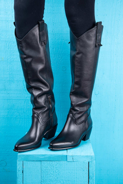 Front-angled view of a model wearing black Novelli high Texan boots by Benheart, featuring a side zip closure.