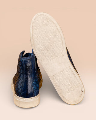 Rear view of Raimondo 8393 indigo woven leather high-top sneakers by Benheart, close-up of white rubber soles.