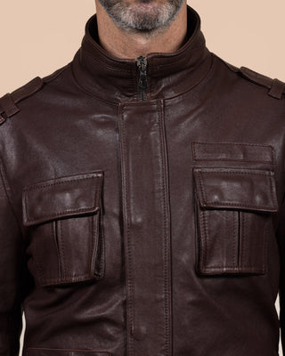 Close-up of the chest pockets and front closure of the Simone jacket by Benheart, in garment-dyed brown lamb leather.