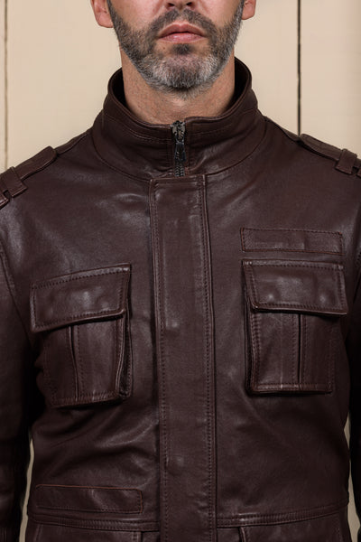 Close-up of the chest pockets and front closure of the Simone jacket by Benheart, in garment-dyed brown lamb leather.