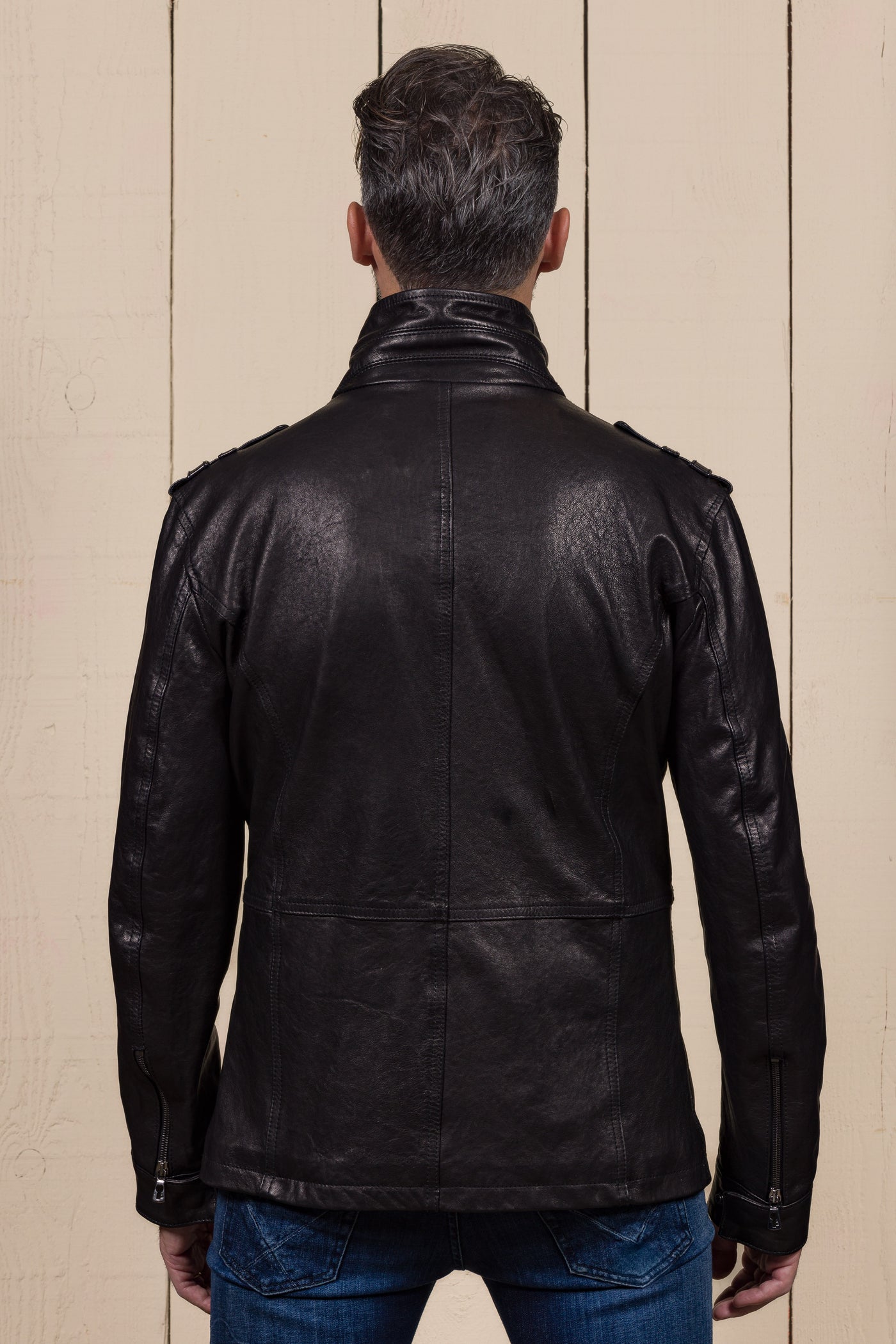 Back view of a model wearing the black Simone leather jacket by Benheart.