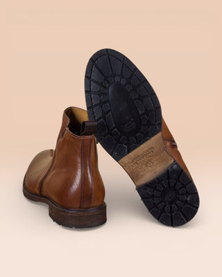 Rear view of Suso cuoio leather Chelsea boots, one turned to show Vibram soles.