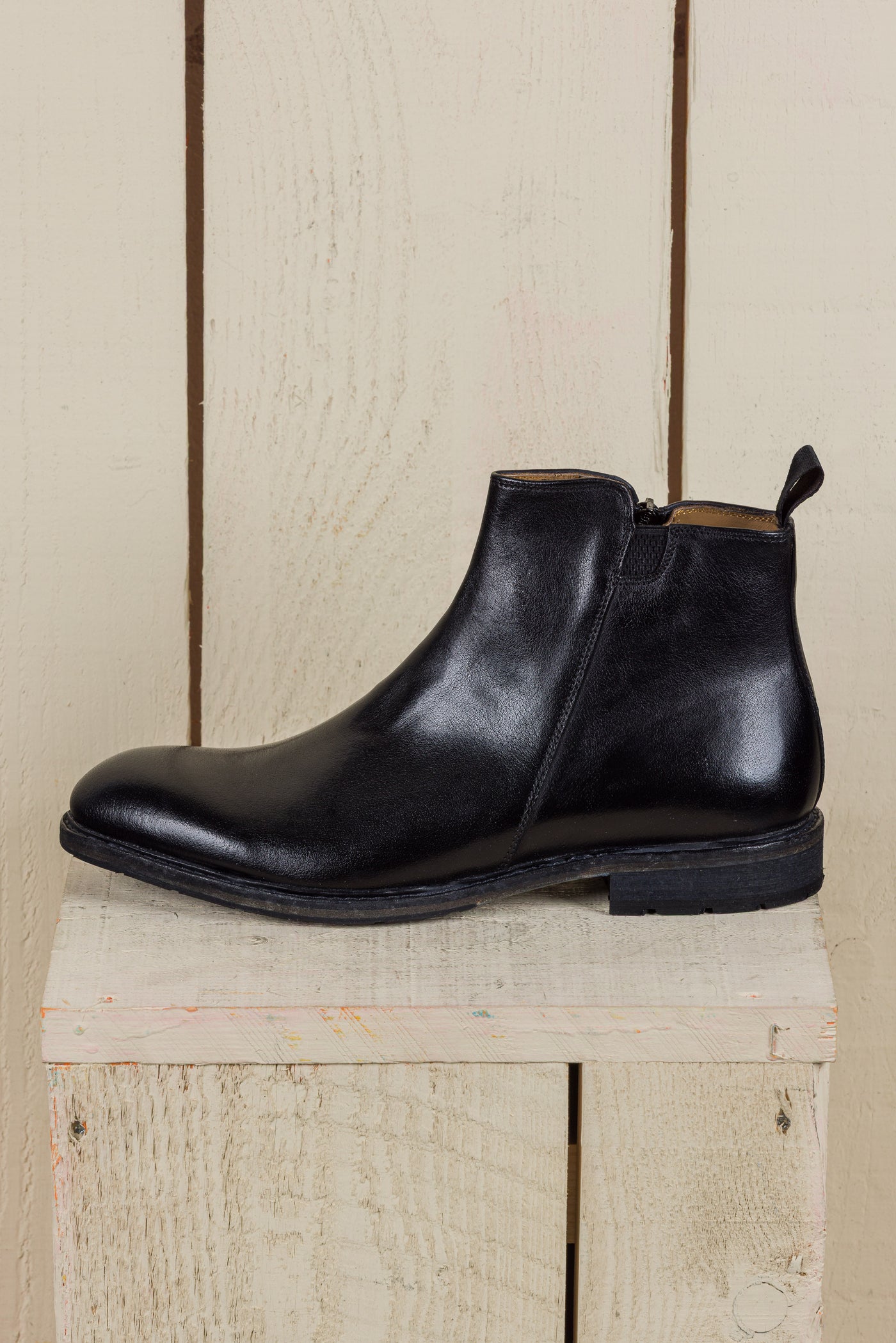 Side view of Suso men’s black leather Chelsea boots with side zippers.