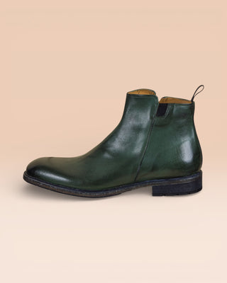 Side view of Suso men’s green leather Chelsea boots with side zippers.