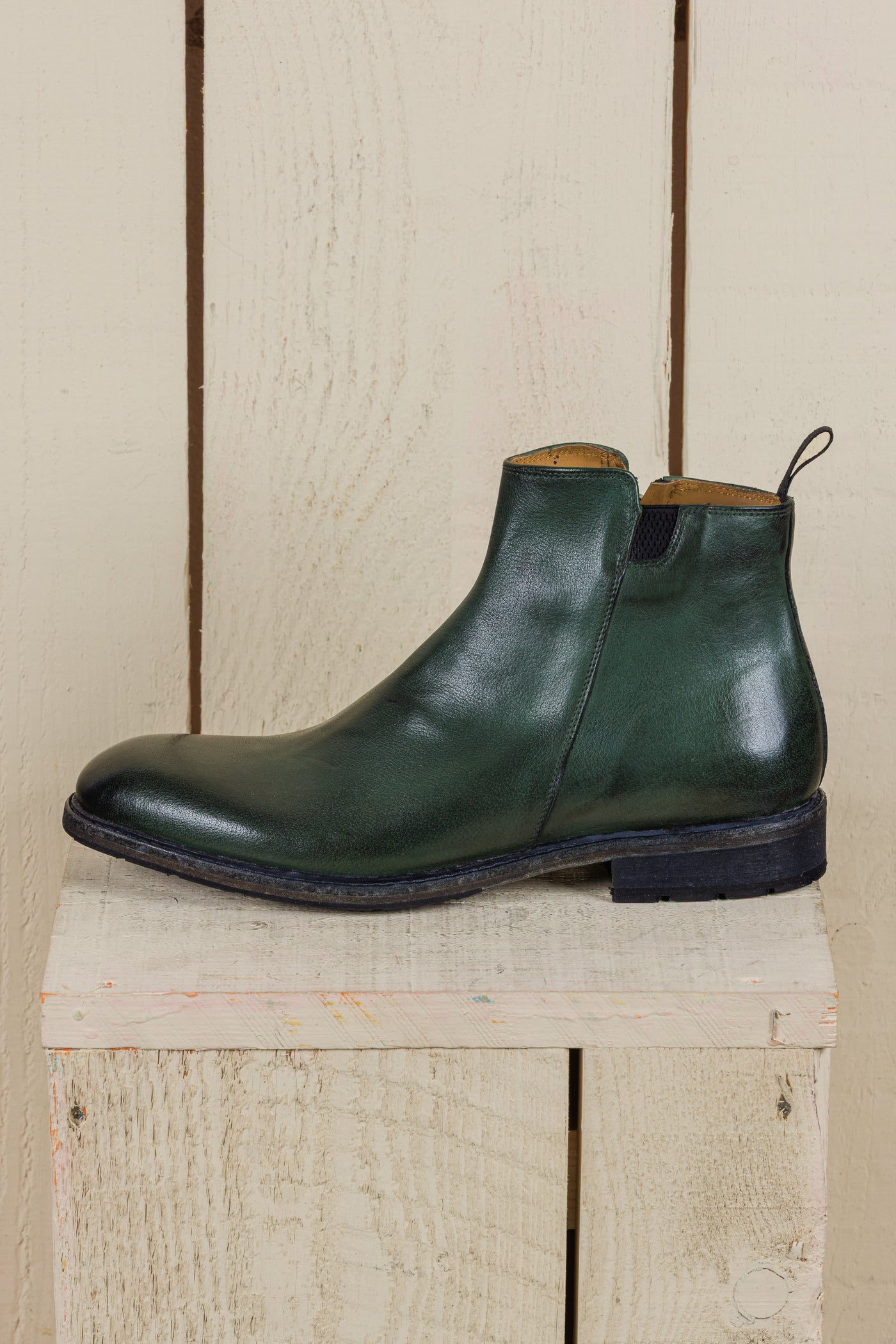 Side view of Suso men’s green leather Chelsea boots with side zippers.