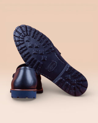 Rear view of the Tesi Q901 blue suede loafers, one turned to show the Vibram soles, handmade in Italy by Benheart.