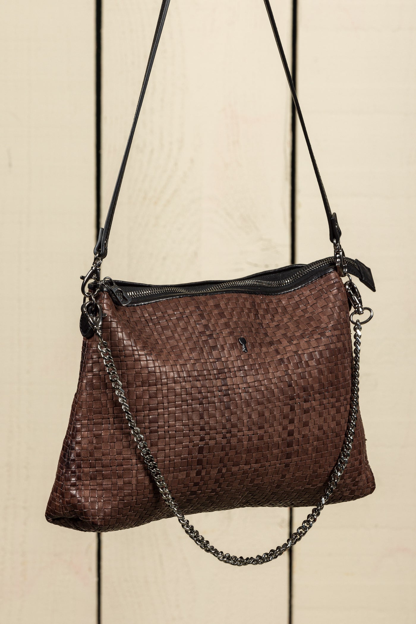 Benheart Violet Intrecciata brown handwoven leather bag, three-quarter rear view, woven leather pattern, chain and leather shoulder strap, zipper closure, luxury designer handbag for women.