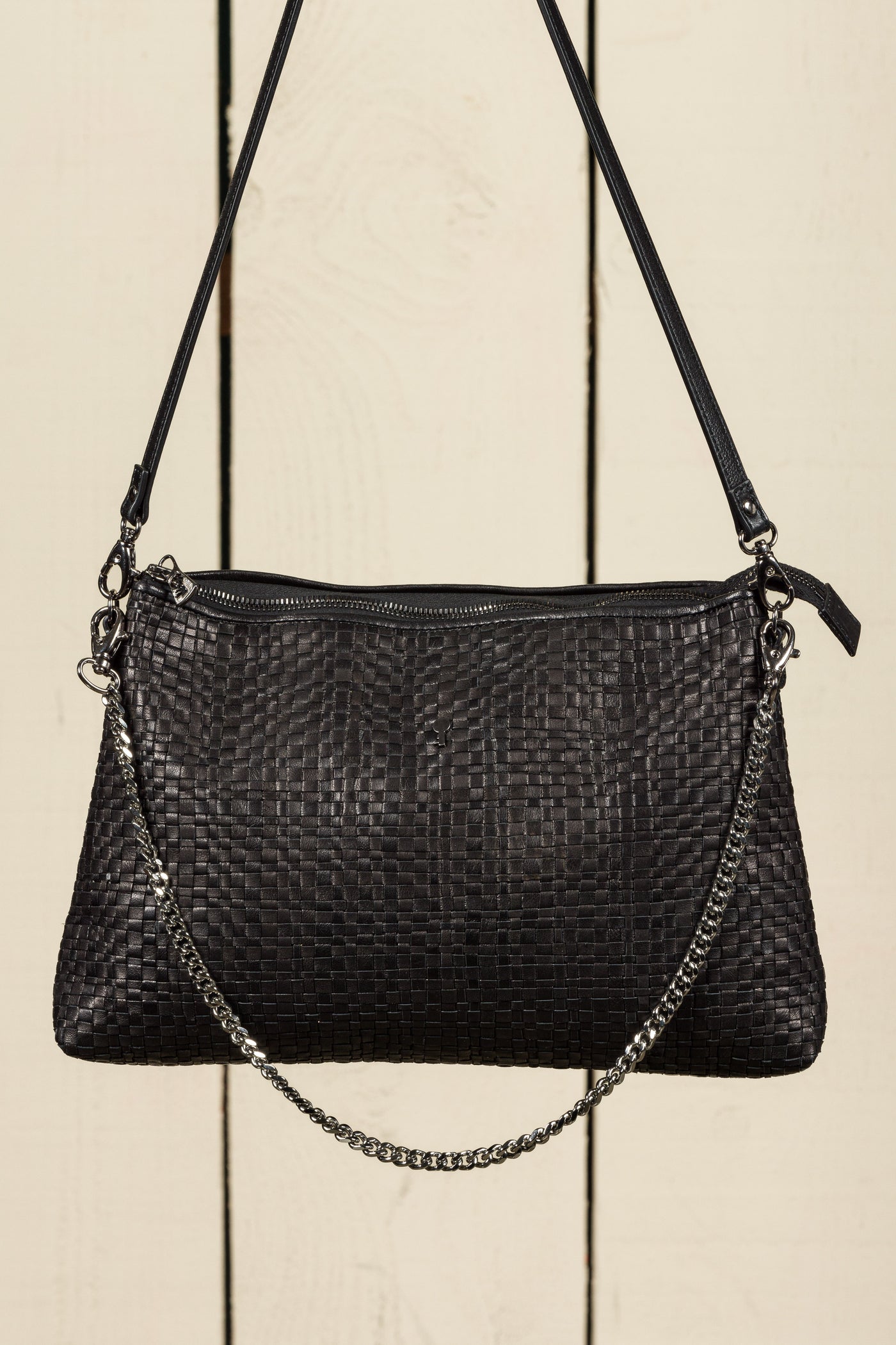 Benheart Violet Intrecciata black handwoven leather bag, front view of the back, showing woven leather pattern, chain and leather shoulder strap, and zipper closure, luxury designer handbag for women.