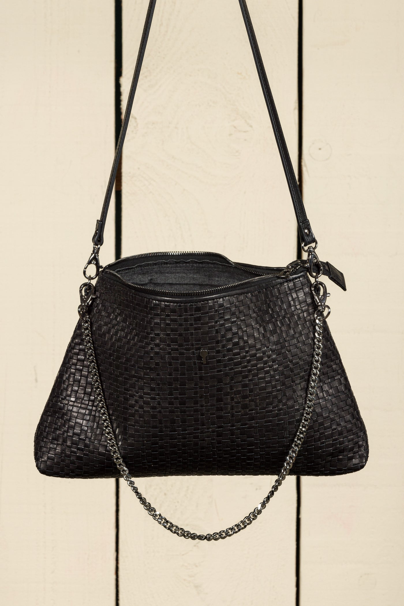 Benheart Violet Intrecciata black handwoven leather bag, front view of the back with open zipper showing interior, woven leather design, chain and leather shoulder strap, luxury designer handbag for women.