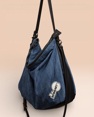 Front angled view of Venice Jeans denim and leather bag with Benheart logo patch.