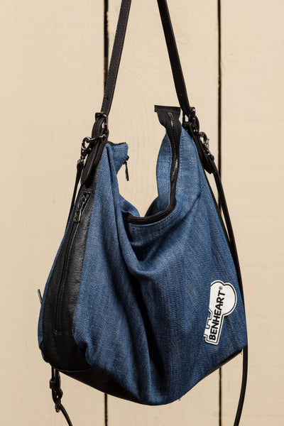 Front view of Venice Jeans denim and leather bag with Benheart logo patch.