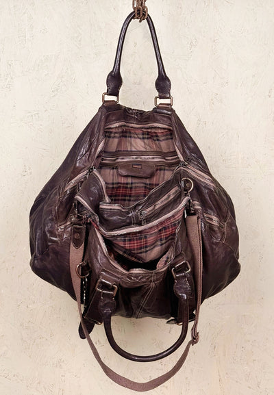 Open view of the Benheart Viaggio unisex brown leather travel bag, showing plaid fabric lining and internal compartments.