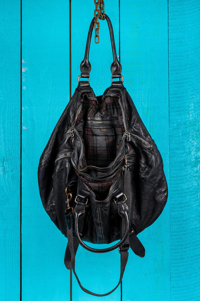 Open view of the Benheart Viaggio unisex black leather travel bag, showing plaid fabric lining and internal compartments.