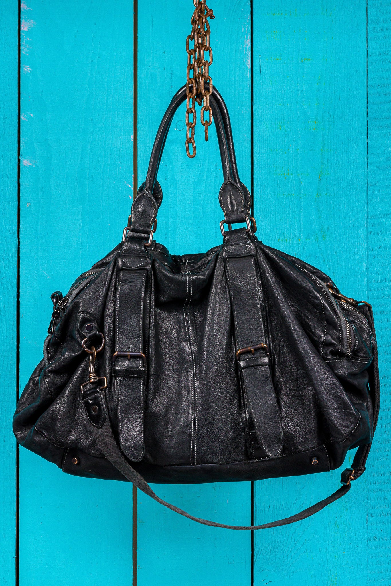Side profile view of the Benheart Viaggio unisex black leather travel bag.