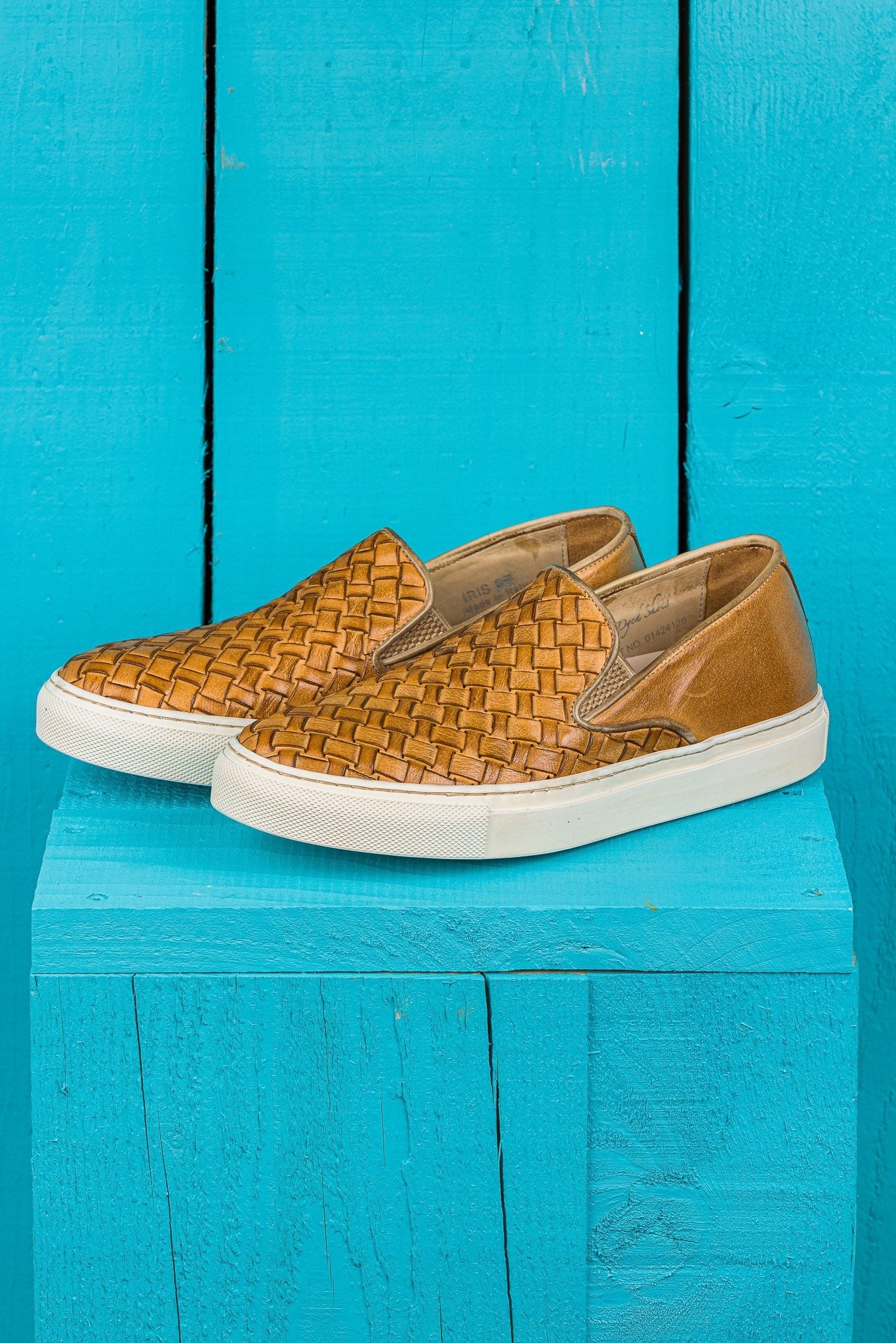 Front angled view of Iris unisex woven slip-on shoes in mahogany leather with white rubber soles.