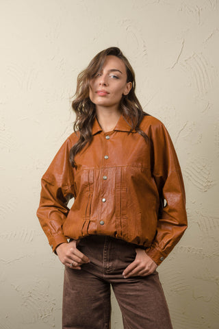 Jasmine cognac leather jacket styled as a bomber with the hem folded inward for a shorter, bomber-style shape