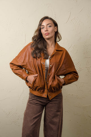 Jasmine women’s cognac leather jacket, front view worn open with both hands in the side pockets